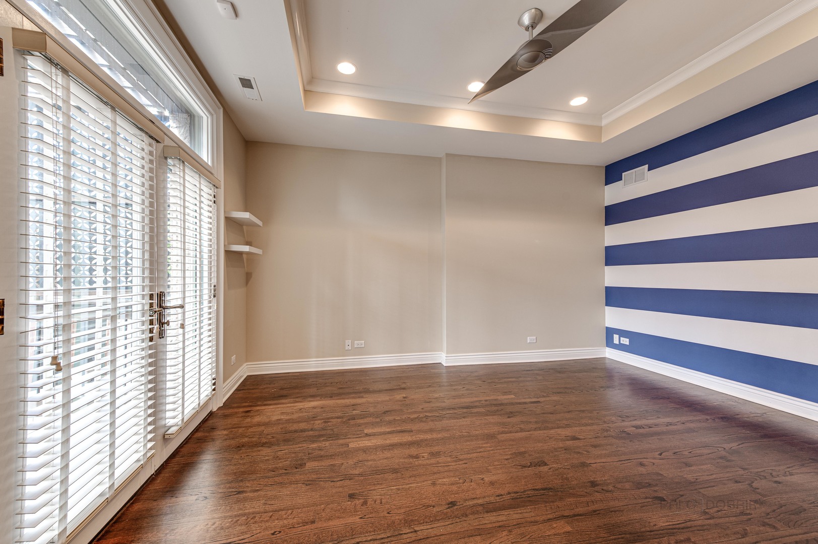 3051 West Logan Boulevard Chicago, IL 60647 - Photo 31 of 52 a view of an empty room with wooden floor and windows