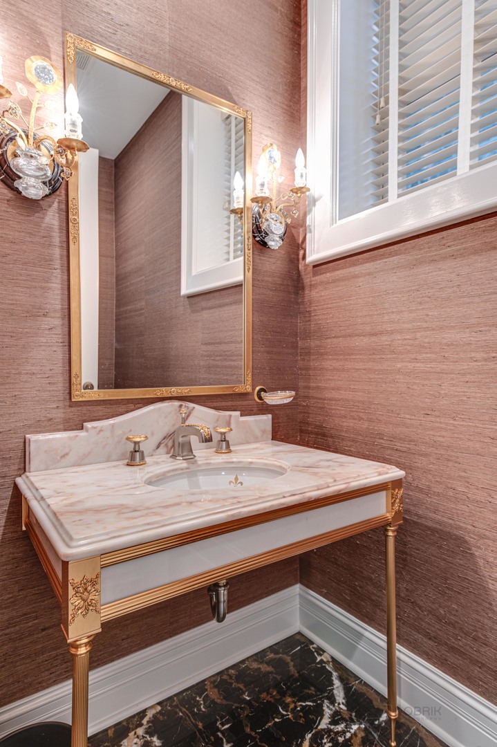 3051 West Logan Boulevard Chicago, IL 60647 - Photo 7 of 52 a bathroom with a sink and a mirror