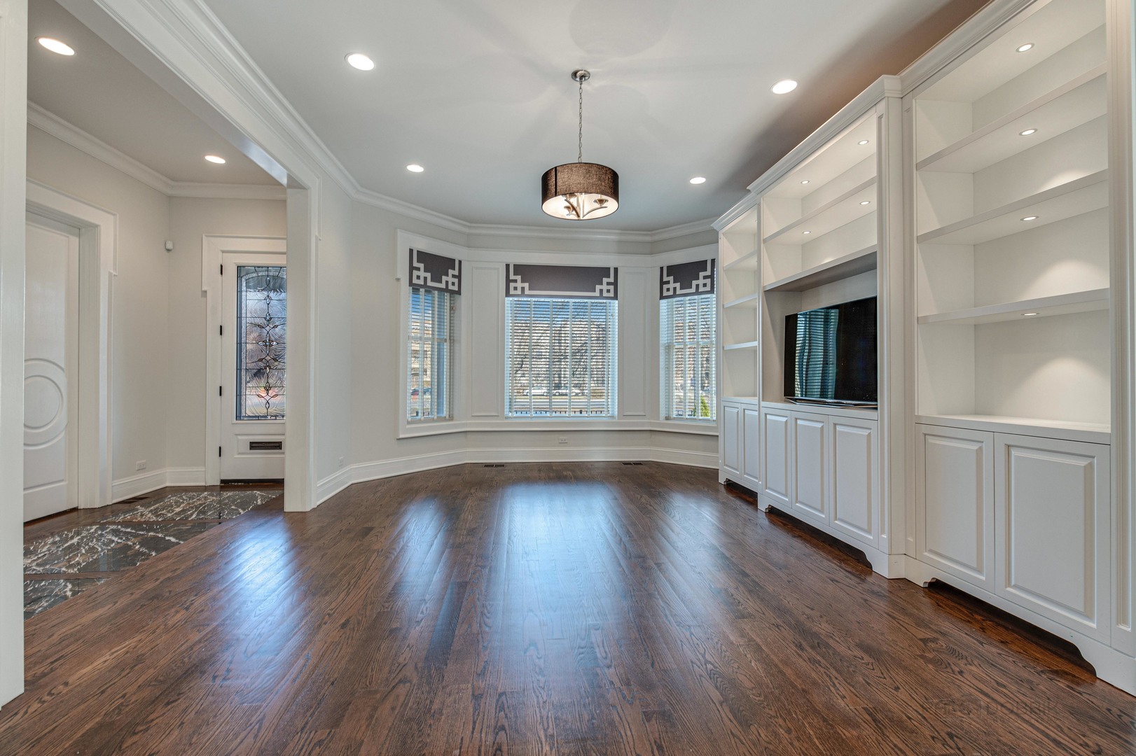 3051 West Logan Boulevard Chicago, IL 60647 - Photo 9 of 52 an empty room with wooden floor and windows