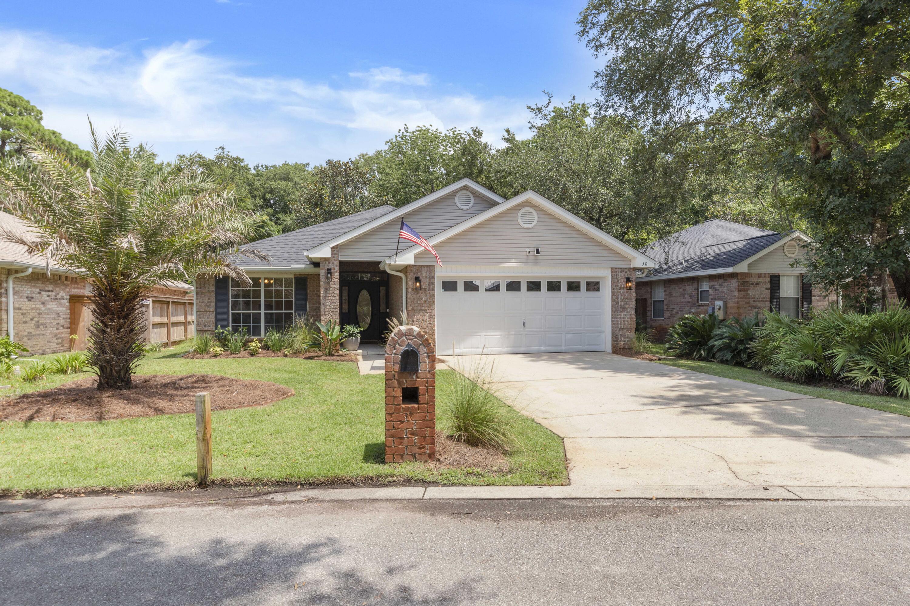 50 Bayou Landing Road Santa Rosa Beach, FL 32459 - Photo 3 of 40 a front view of a house with a yard