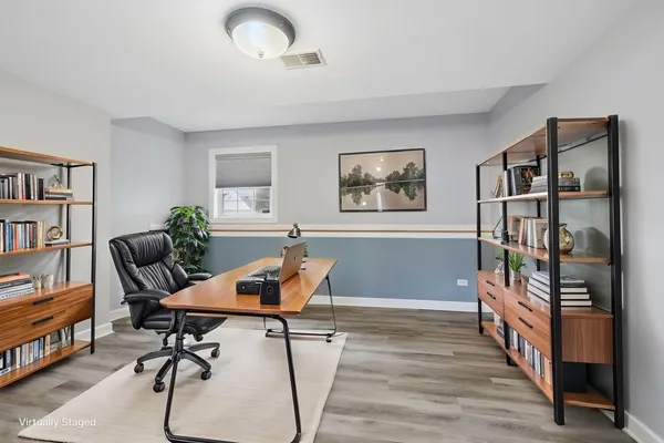 a living room with furniture and a book shelf
