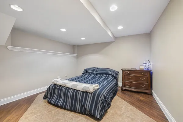 a bedroom with a bed and cabinet