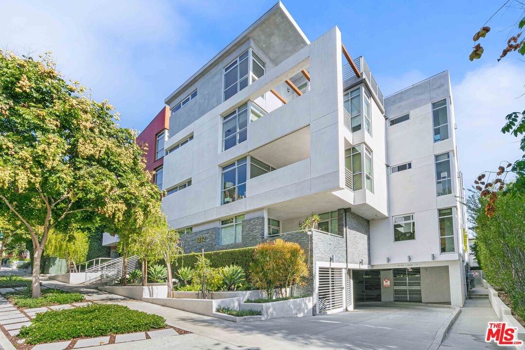 1232 North Kings Road, Unit 105 West Hollywood, CA 90069 - Photo 2 of 22 a front view of a building with street view