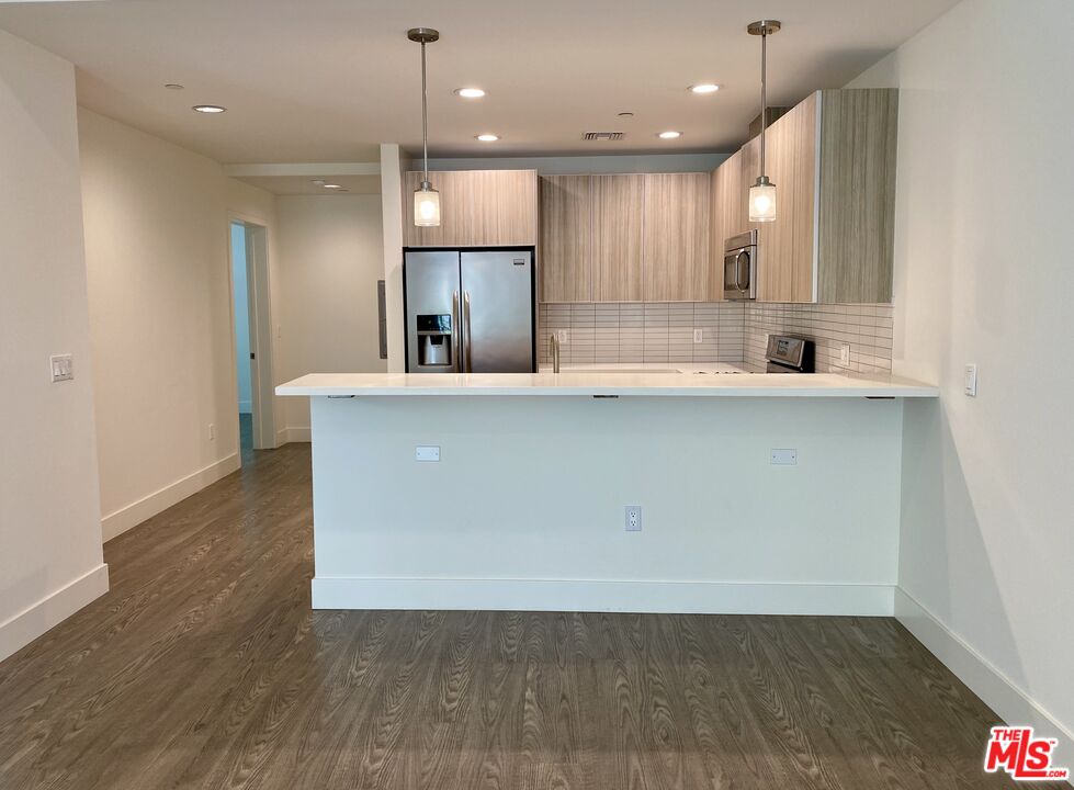 1232 North Kings Road, Unit 105 West Hollywood, CA 90069 - Photo 4 of 22 a view of kitchen with cabinets and wooden floor