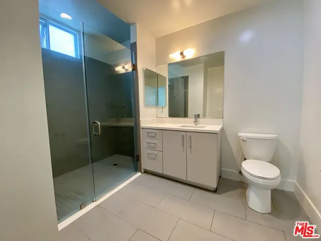 a bathroom with a toilet sink and shower
