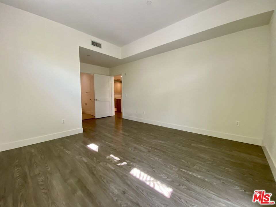 1232 North Kings Road, Unit 105 West Hollywood, CA 90069 - Photo 8 of 22 a view of an empty room and window