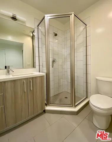 a bathroom with a shower and a toilet