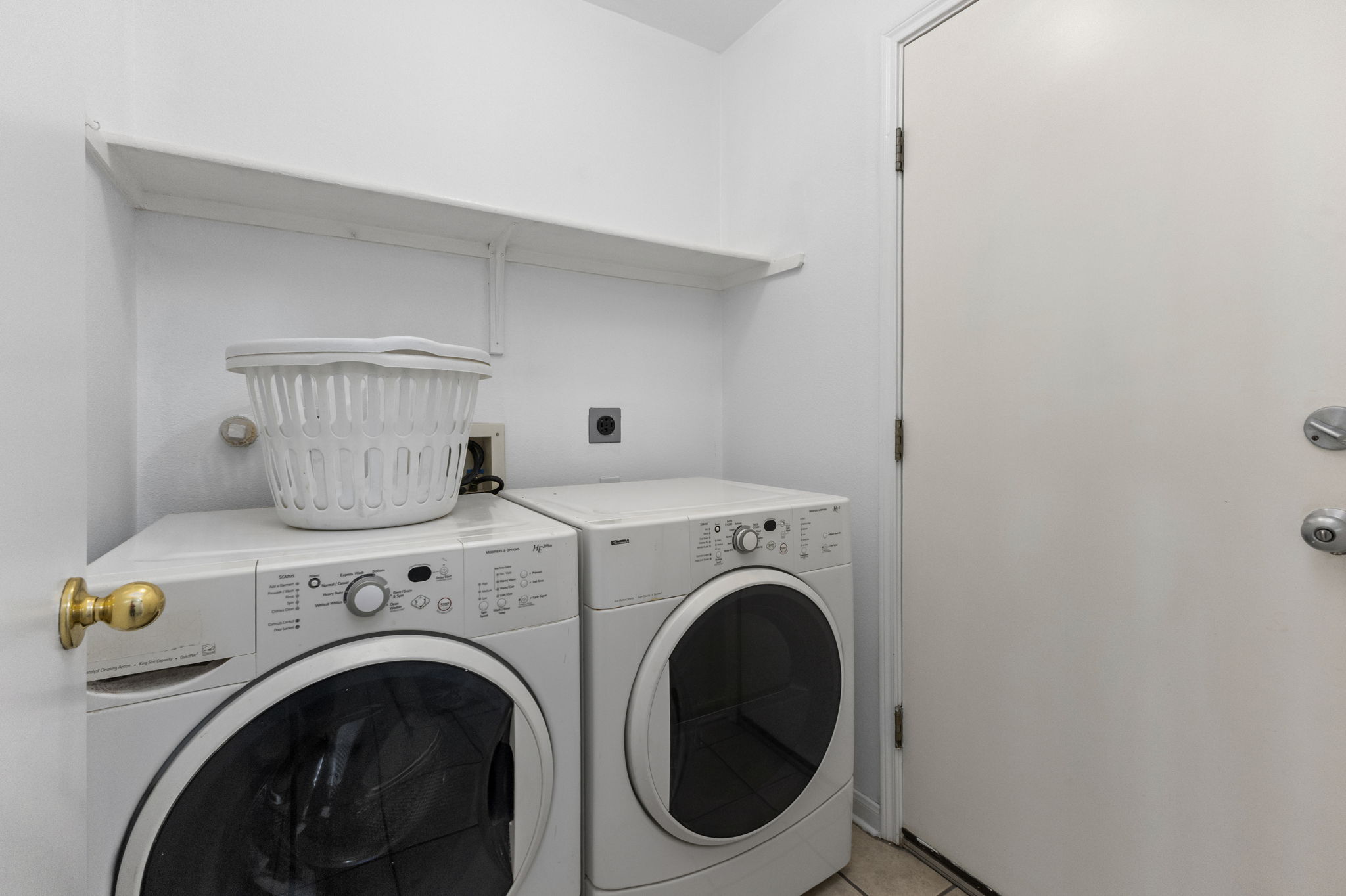 290 Bailey Loop Kyle, TX 78640 - Photo 17 of 33 Dedicated laundry area featuring a built-in wall shelf and a white door with brass hardware