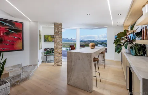 a kitchen with stainless steel appliances kitchen island granite countertop a stove a sink and a microwave
