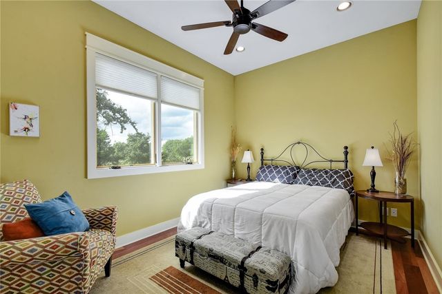 633 Trails End Road Johnson City, TX 78636 - Photo 19 of 29 Rich hardwood floors and soaring ceilings define this serene bedroom space.
