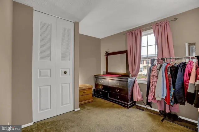 a view of walk in closet with clothes