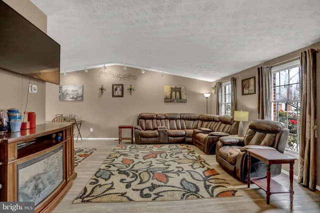 a living room with fireplace furniture and a flat screen tv