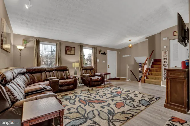 a bedroom with furniture and a rug