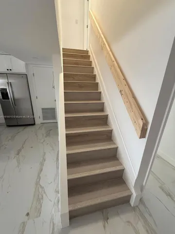 a kitchen with a refrigerator a sink and dishwasher