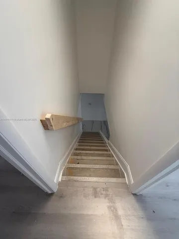 a bathroom with a granite countertop toilet a sink a shower and a mirror