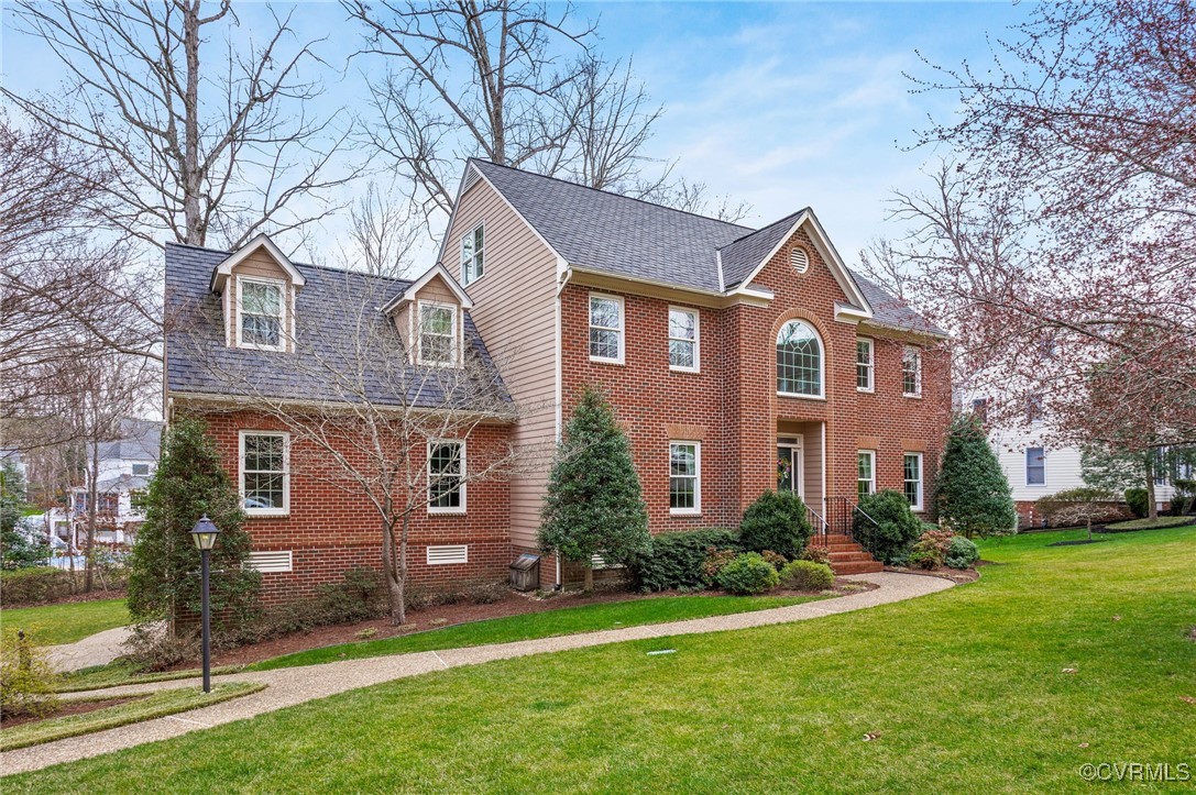 5219 Clipper Cove Road Midlothian, VA 23112 - Photo 1 of 49 a front view of a house with a garden and trees