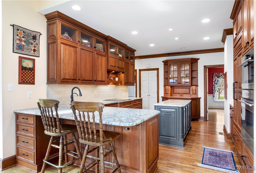 5219 Clipper Cove Road Midlothian, VA 23112 - Photo 12 of 49 a kitchen with granite countertop a table chairs stove and cabinets