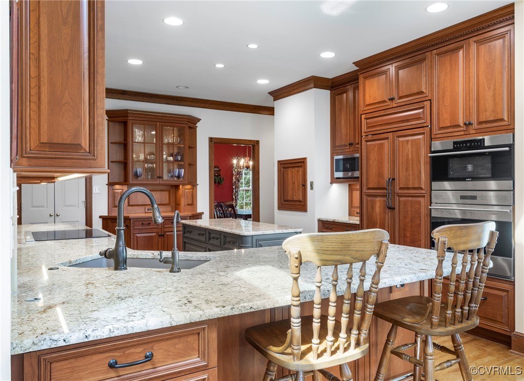 5219 Clipper Cove Road Midlothian, VA 23112 - Photo 13 of 49 a kitchen with stainless steel appliances granite countertop a stove top oven a sink a dining table and chairs