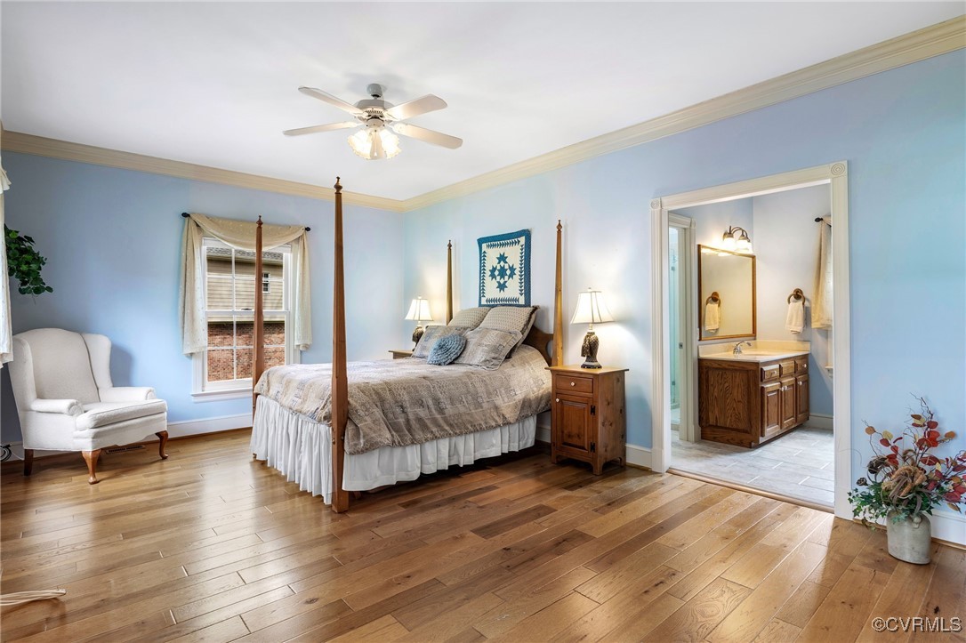 5219 Clipper Cove Road Midlothian, VA 23112 - Photo 24 of 49 a spacious bedroom with a large bed and a chandelier