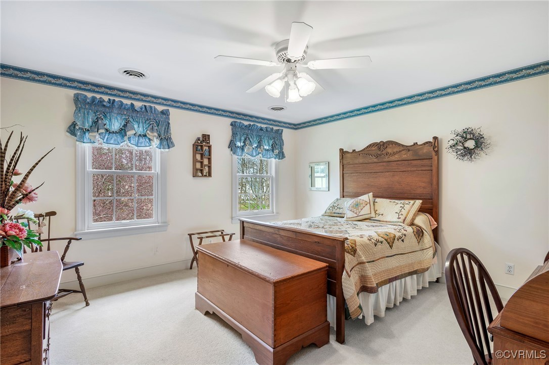 5219 Clipper Cove Road Midlothian, VA 23112 - Photo 35 of 49 a bedroom with a bed and a chandelier