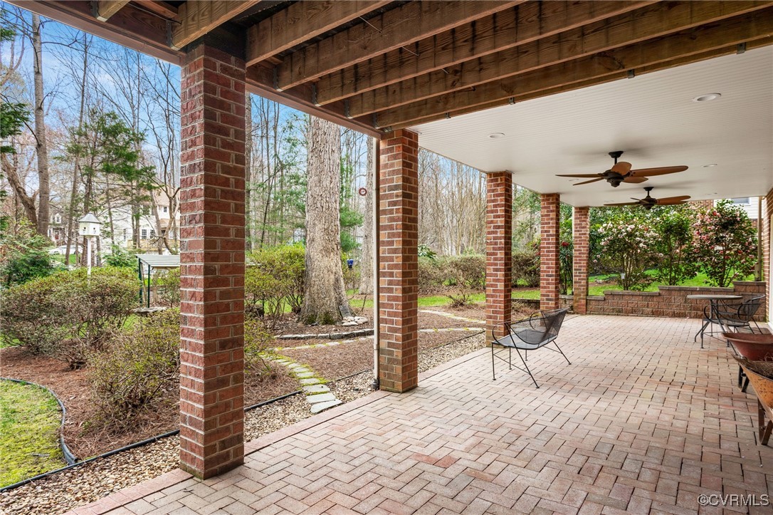 5219 Clipper Cove Road Midlothian, VA 23112 - Photo 43 of 49 a porch with a table and chairs next to a yard