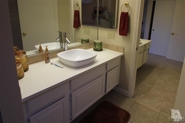 3948 Southhampton Road Moorpark, CA 93021 - Photo 13 of 30 a bathroom with a sink and a mirror