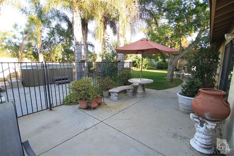 3948 Southhampton Road Moorpark, CA 93021 - Photo 30 of 30 a view of a table and chair under an umbrella in backyard