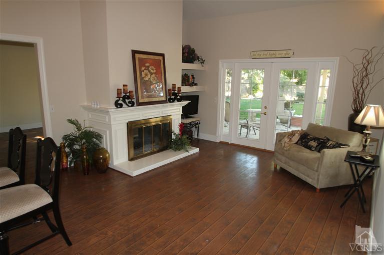 3948 Southhampton Road Moorpark, CA 93021 - Photo 9 of 30 a living room with furniture wooden floor and a fireplace
