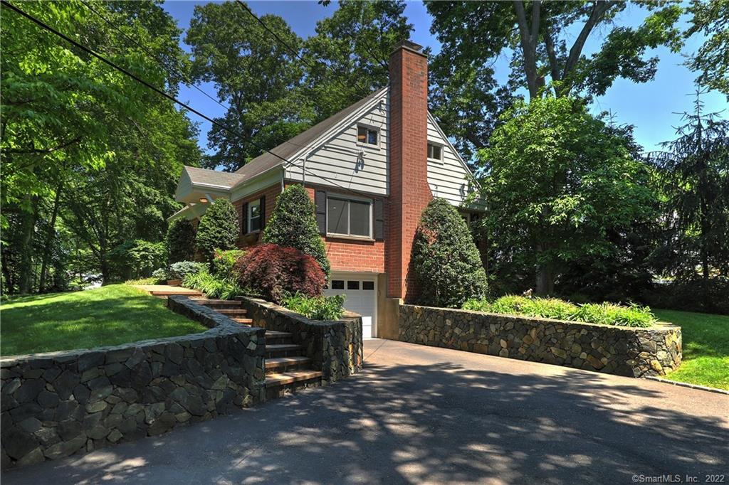 a view of a house with a yard and a park