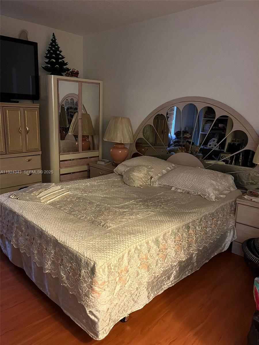 525 West 69th Street, Unit 207 Hialeah, FL 33014 - Photo 11 of 12 a bedroom with a bed and flat screen tv