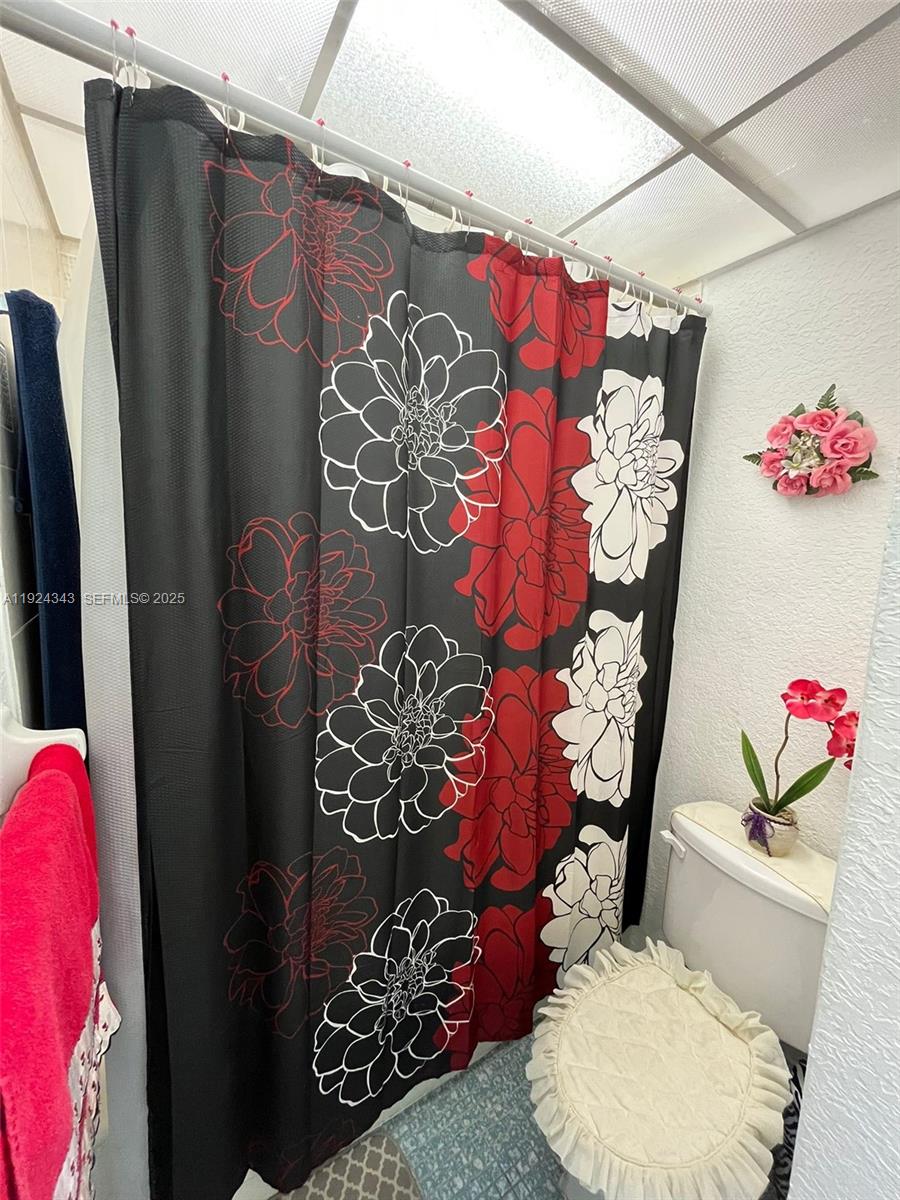 525 West 69th Street, Unit 207 Hialeah, FL 33014 - Photo 2 of 12 a bathroom with a toilet sink and shower