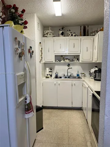 a kitchen with cabinets and appliances