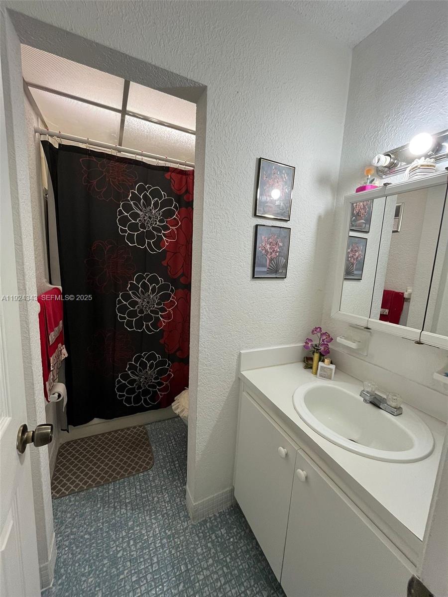 525 West 69th Street, Unit 207 Hialeah, FL 33014 - Photo 6 of 12 a bathroom with a sink and a mirror