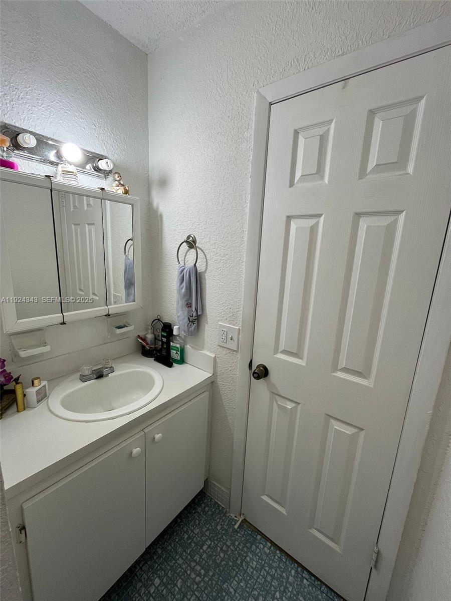 525 West 69th Street, Unit 207 Hialeah, FL 33014 - Photo 7 of 12 a bathroom with a sink and a mirror