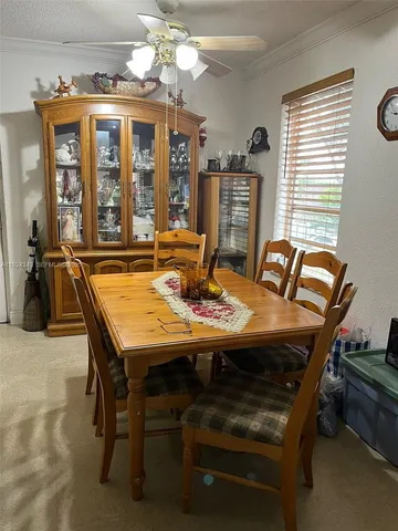 a view of a dining room with furniture window and outside view