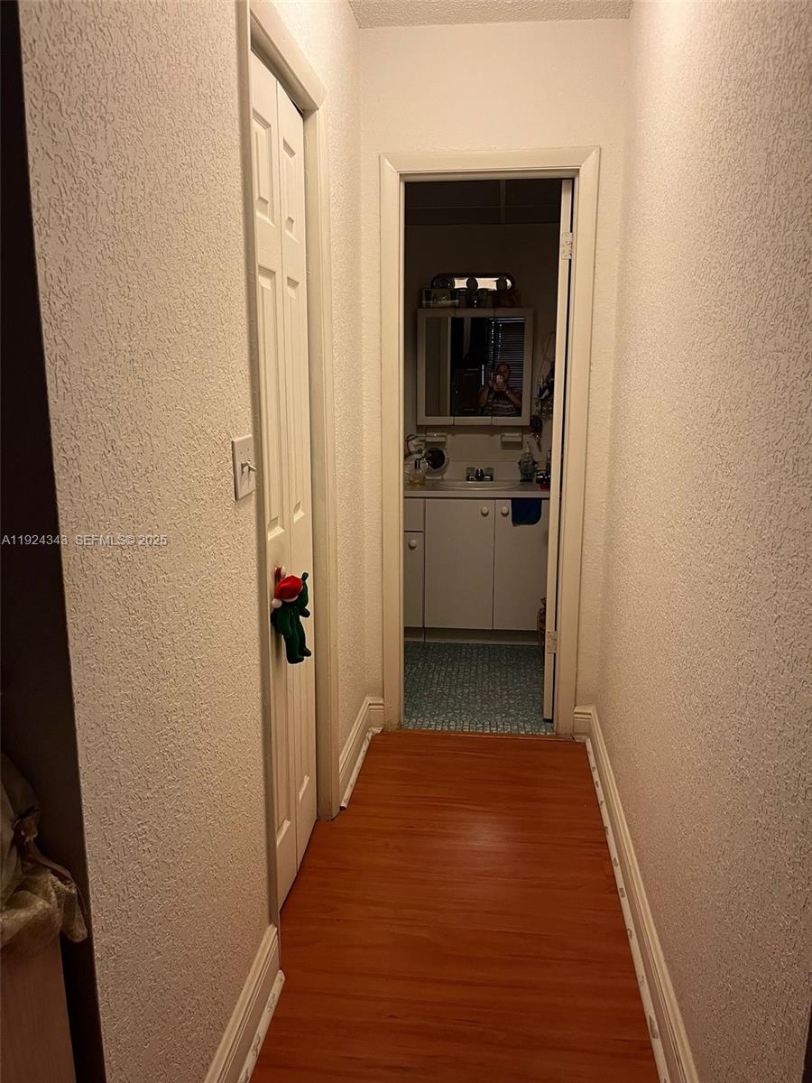 525 West 69th Street, Unit 207 Hialeah, FL 33014 - Photo 10 of 12 a view of a hallway with a livingroom and a bathroom