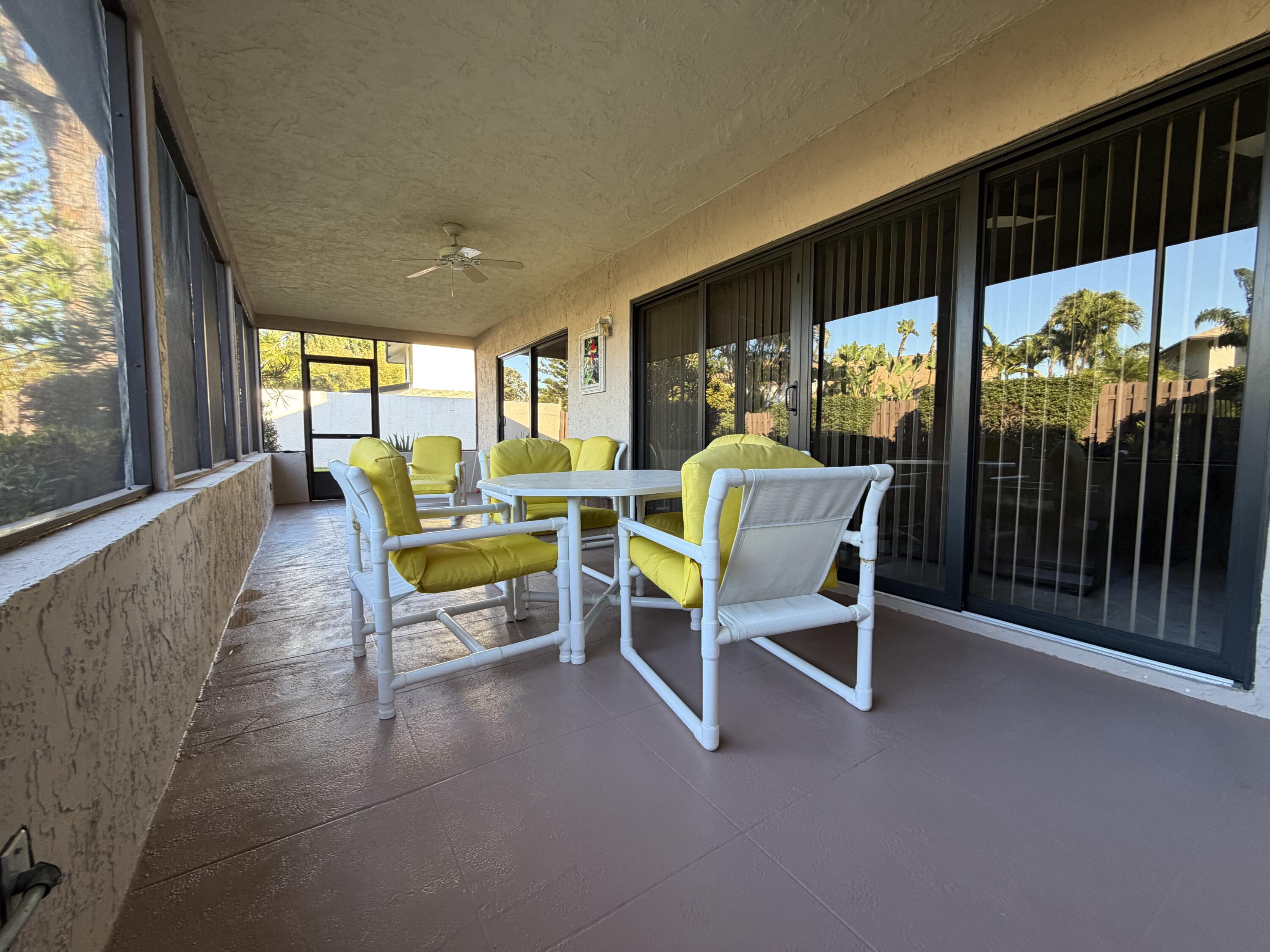 354 Southwest 28th Avenue Delray Beach, FL 33445 - Photo 12 of 54 a living room with furniture and a floor to ceiling window