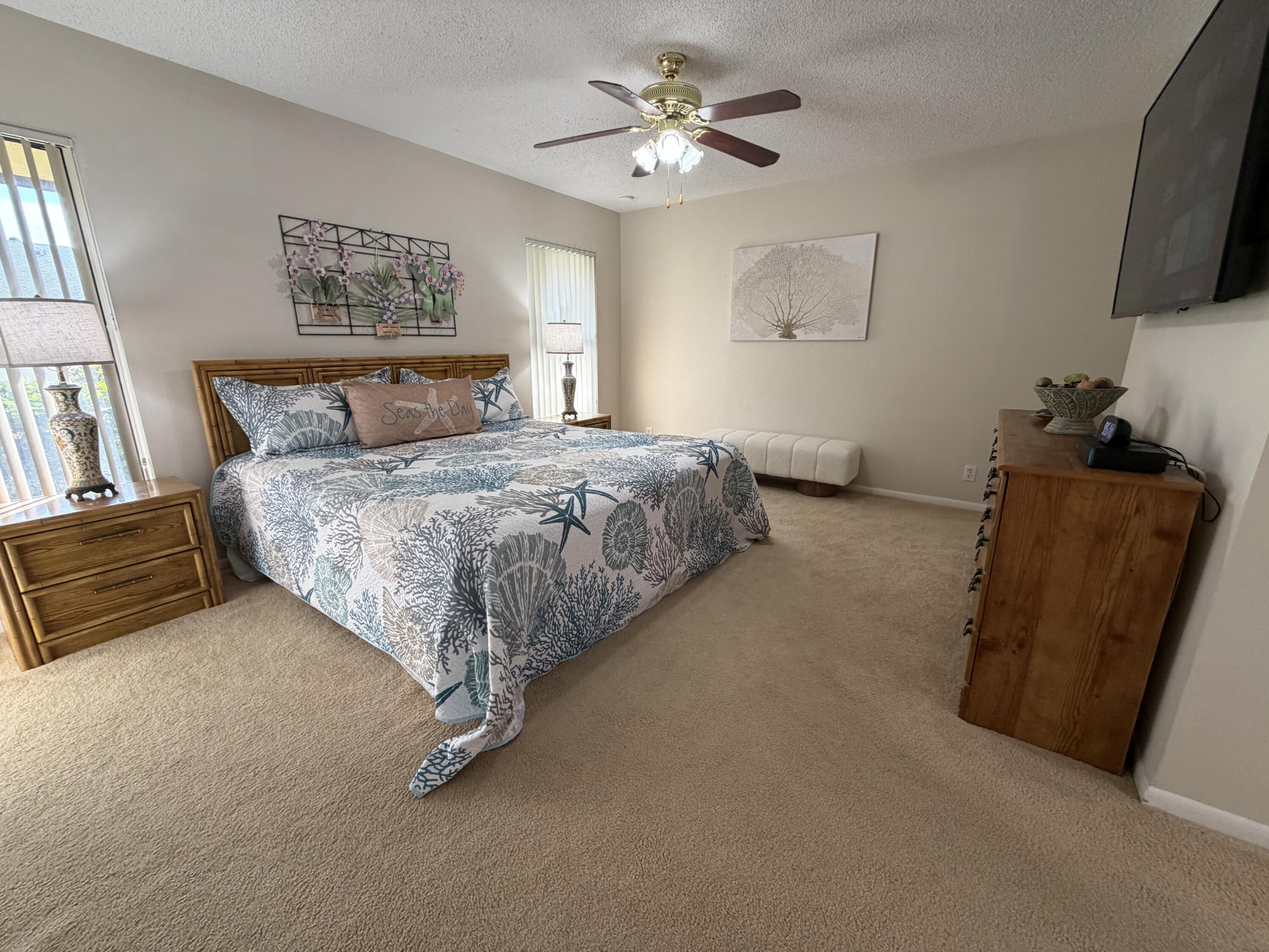 354 Southwest 28th Avenue Delray Beach, FL 33445 - Photo 14 of 54 a spacious bedroom with a bed and a flat screen television