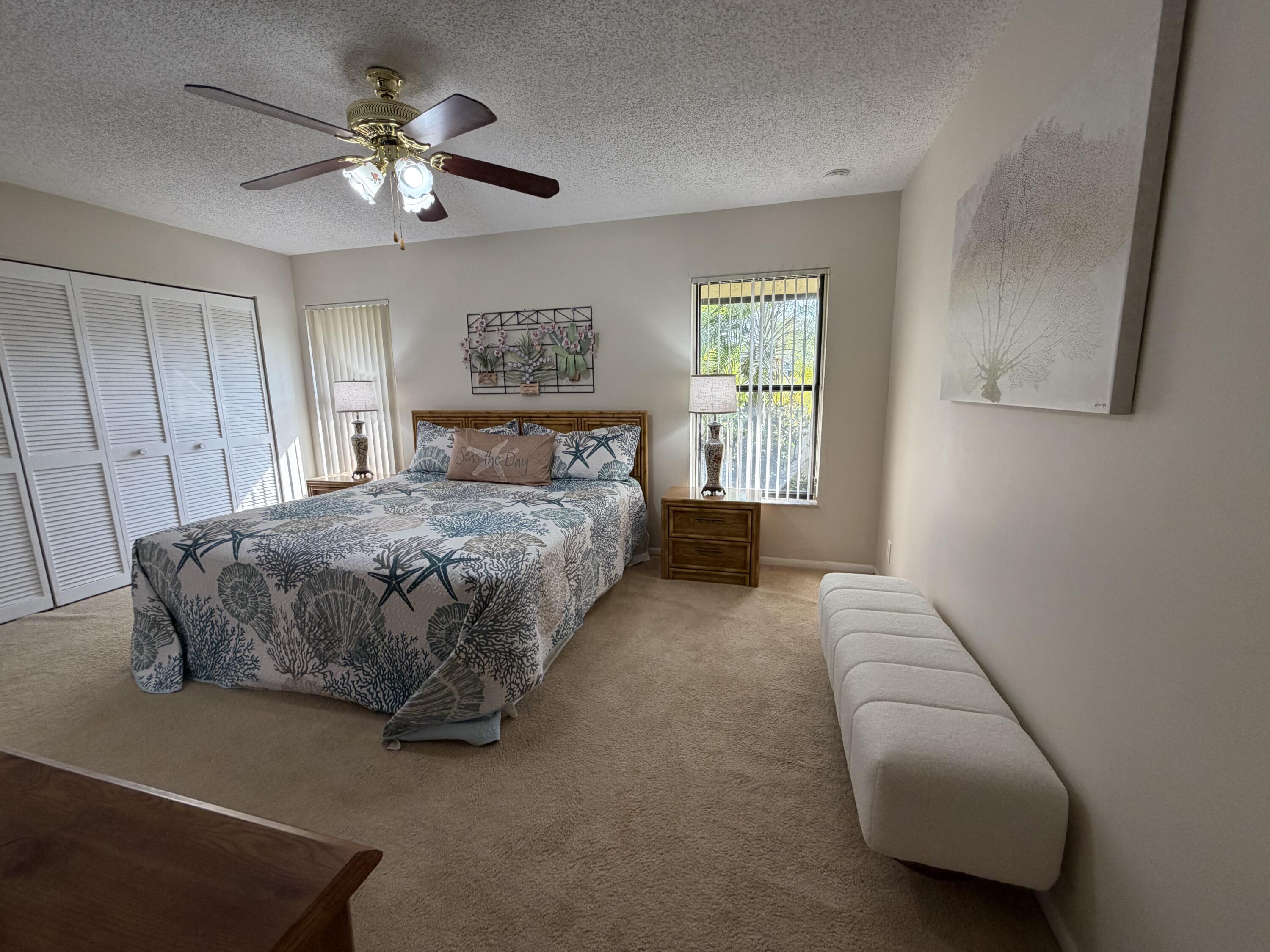 354 Southwest 28th Avenue Delray Beach, FL 33445 - Photo 16 of 54 a bedroom with a large bed and a chandelier