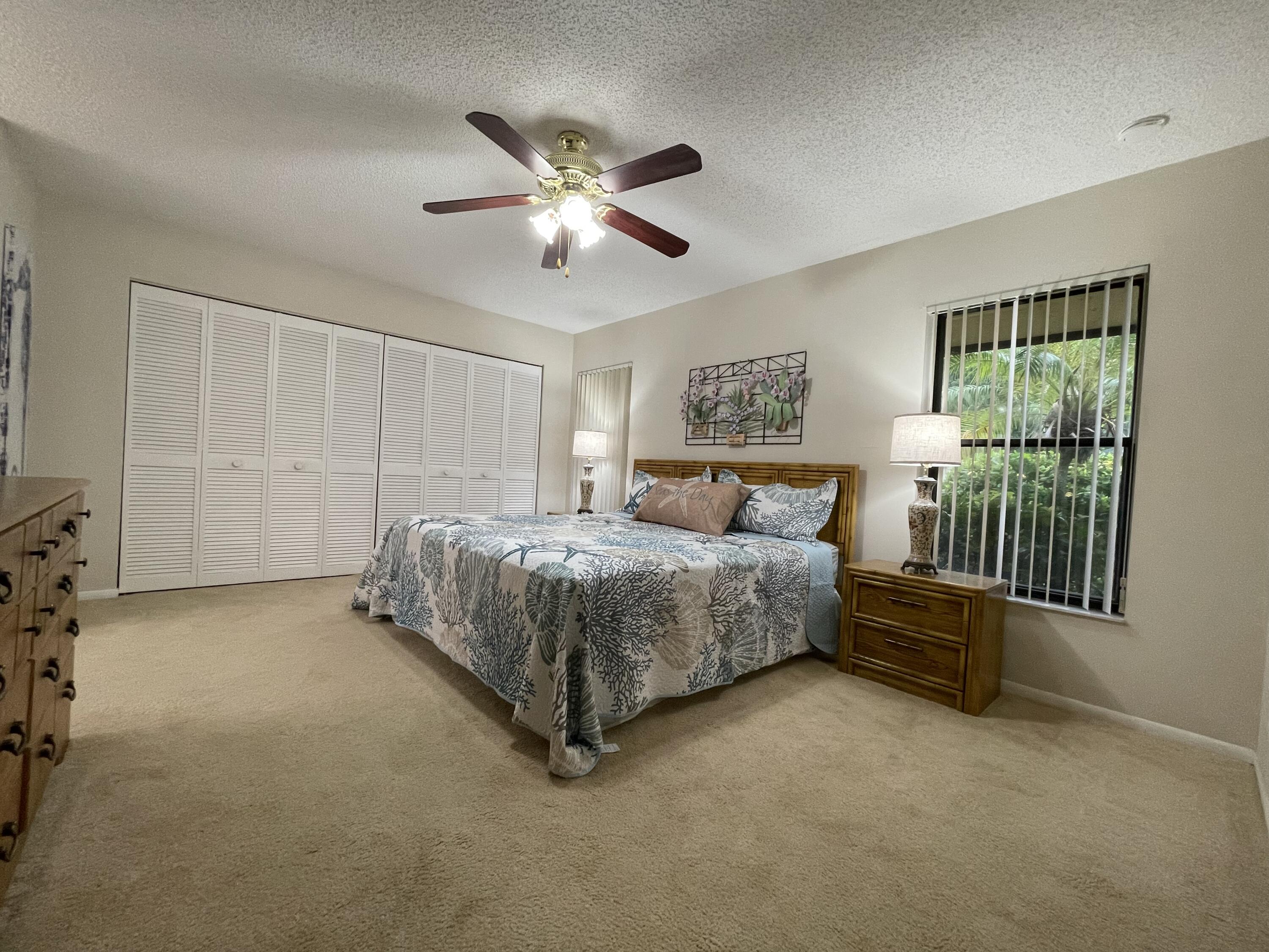 354 Southwest 28th Avenue Delray Beach, FL 33445 - Photo 17 of 54 a bedroom with a bed and a chandelier