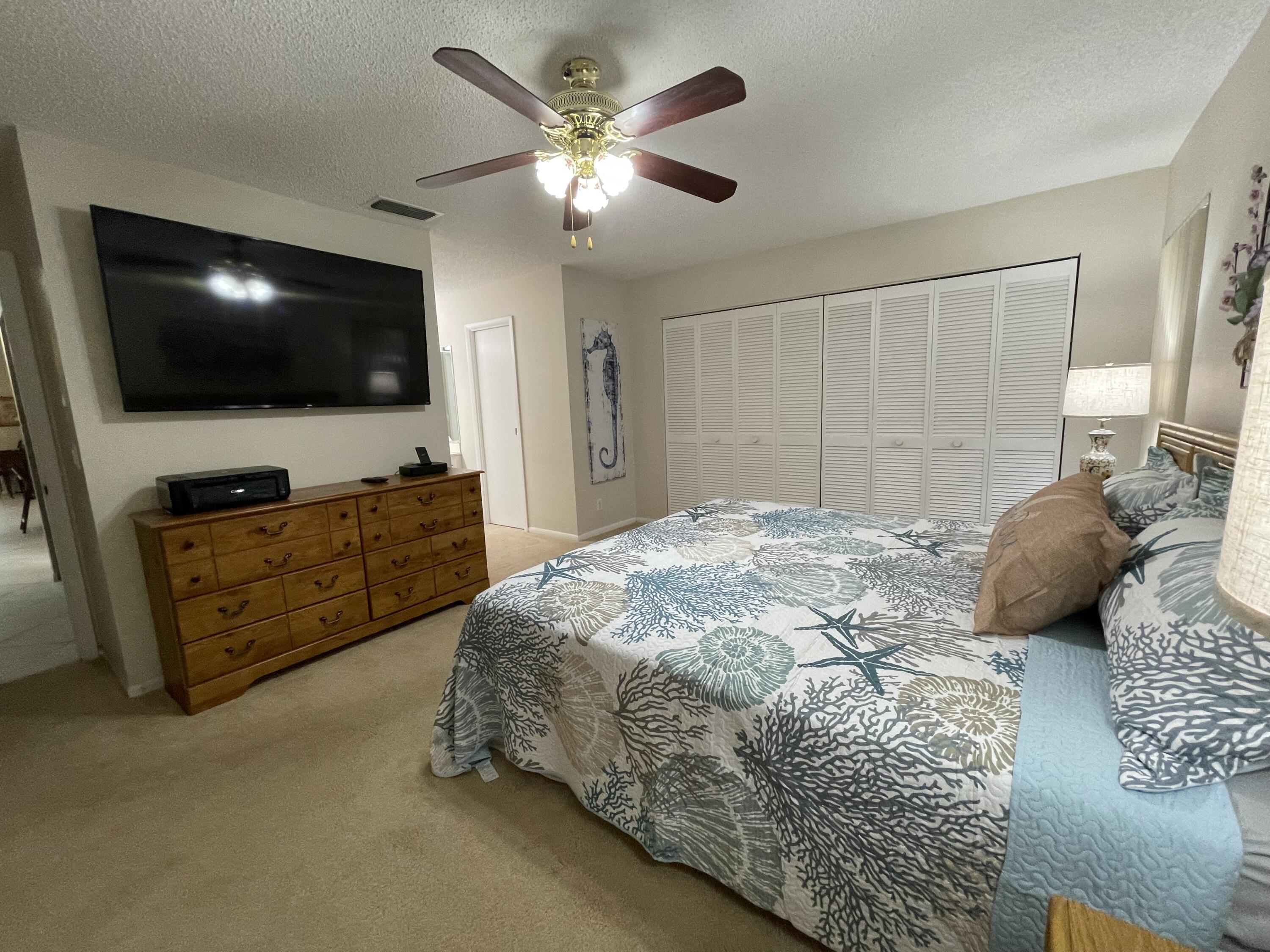 354 Southwest 28th Avenue Delray Beach, FL 33445 - Photo 18 of 54 a bedroom with a bed and a flat screen tv