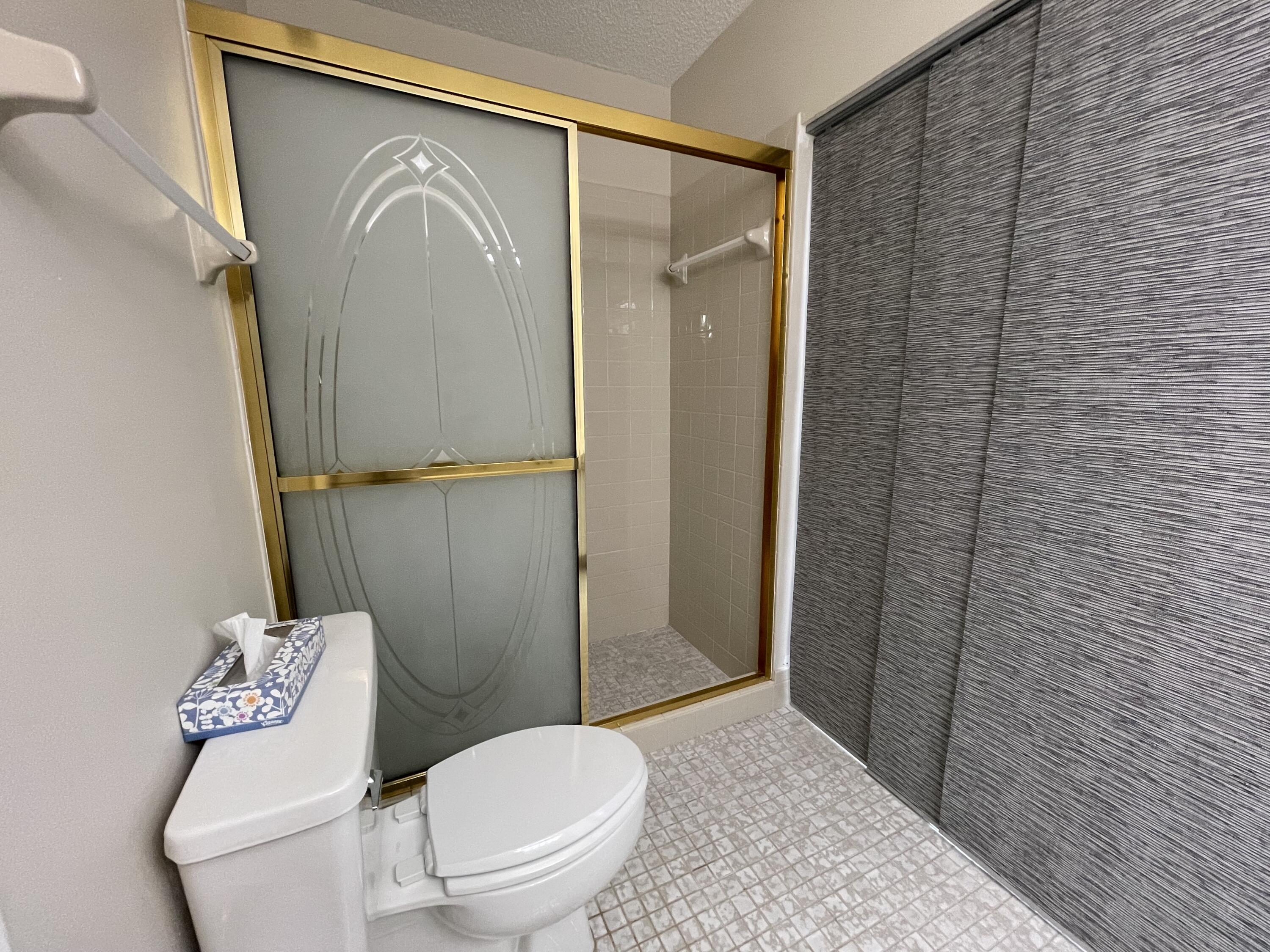 354 Southwest 28th Avenue Delray Beach, FL 33445 - Photo 21 of 54 a bathroom with a toilet and a shower