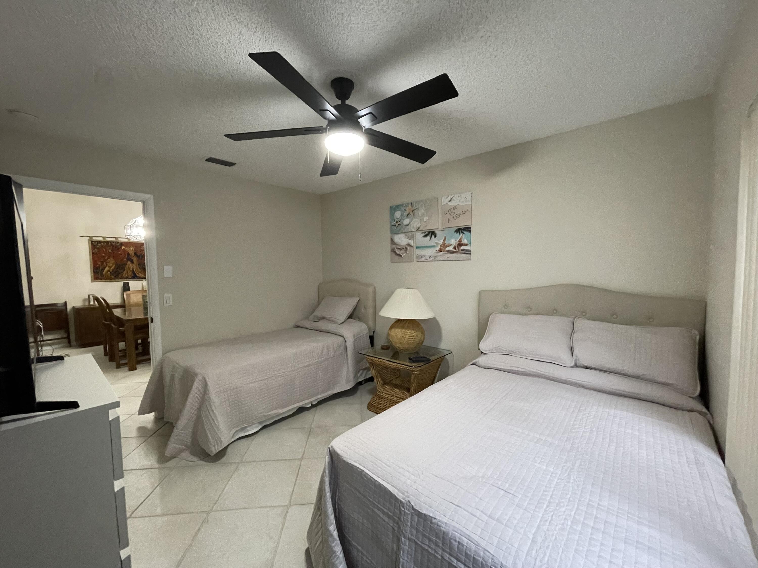 354 Southwest 28th Avenue Delray Beach, FL 33445 - Photo 28 of 54 a bedroom with two beds and ceiling fan