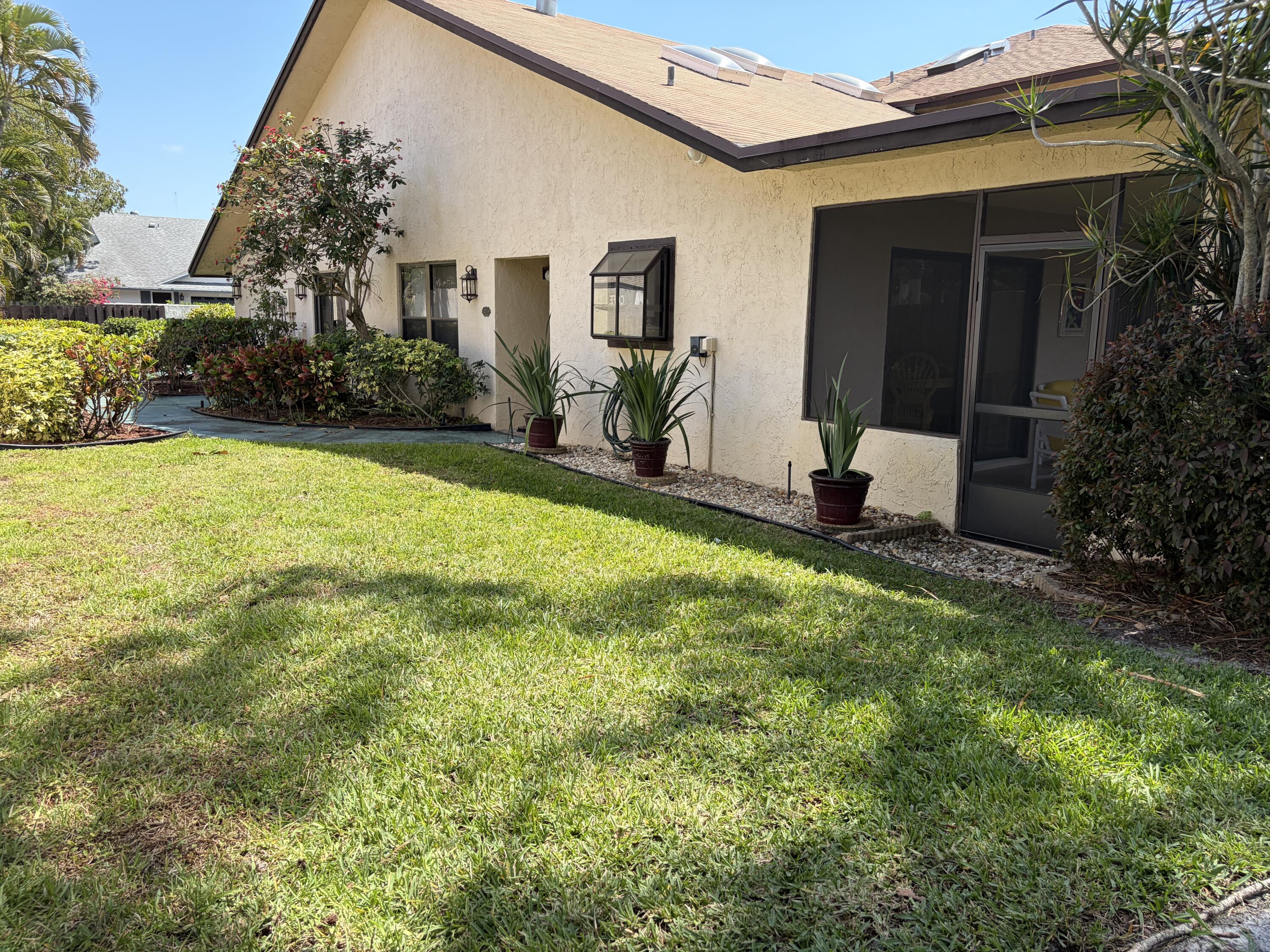 354 Southwest 28th Avenue Delray Beach, FL 33445 - Photo 36 of 54 a view of a house with a yard and plants