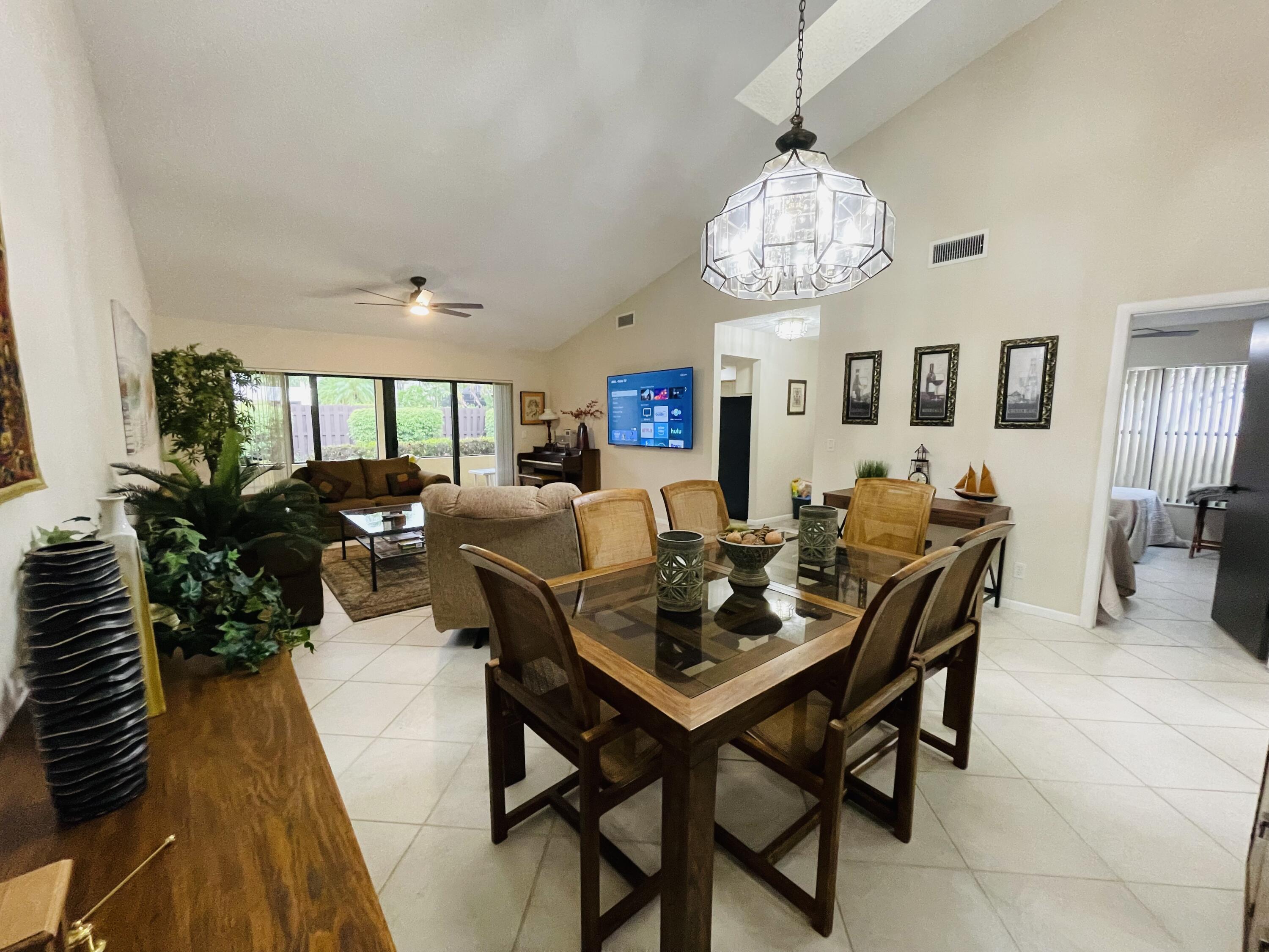 354 Southwest 28th Avenue Delray Beach, FL 33445 - Photo 5 of 54 a view of a dining room with furniture and a chandelier
