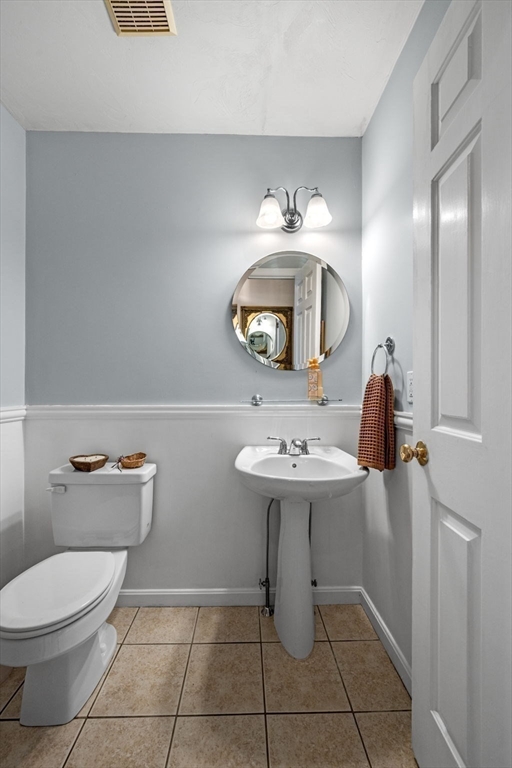 35 Collins Street, Unit 73 Danvers, MA 01923 - Photo 15 of 30 a bathroom with a toilet sink and mirror