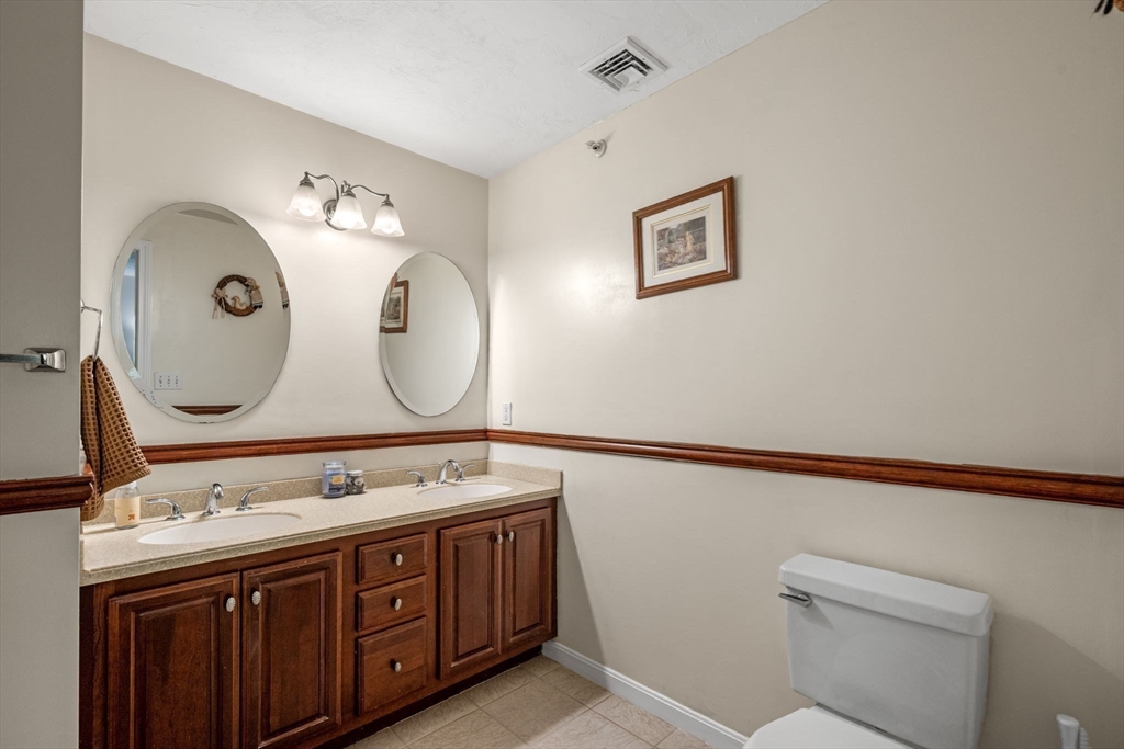 35 Collins Street, Unit 73 Danvers, MA 01923 - Photo 18 of 30 a bathroom with a double vanity sink and a mirror