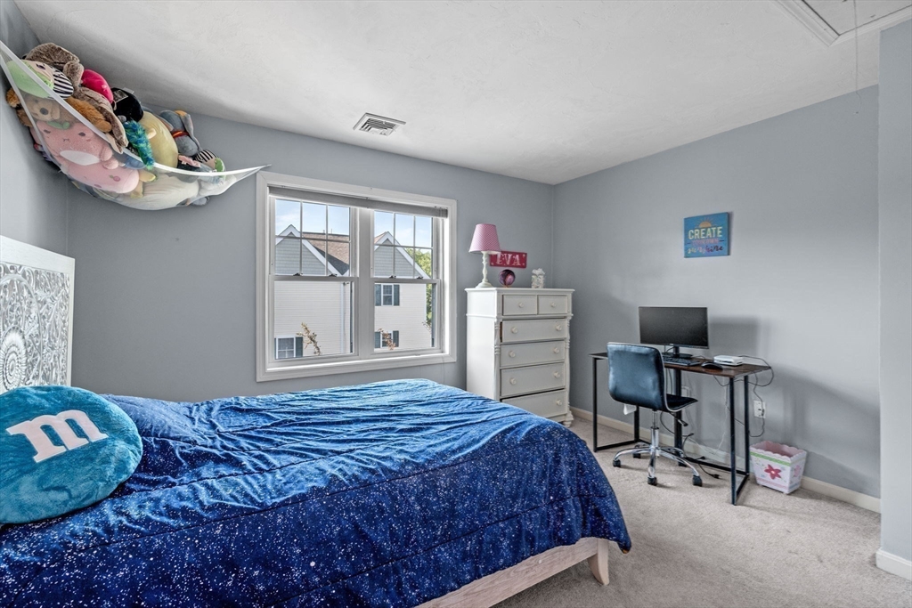 35 Collins Street, Unit 73 Danvers, MA 01923 - Photo 21 of 30 a bedroom with a bed and a chair in it