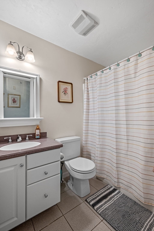 35 Collins Street, Unit 73 Danvers, MA 01923 - Photo 22 of 30 a bathroom with a toilet a sink and mirror