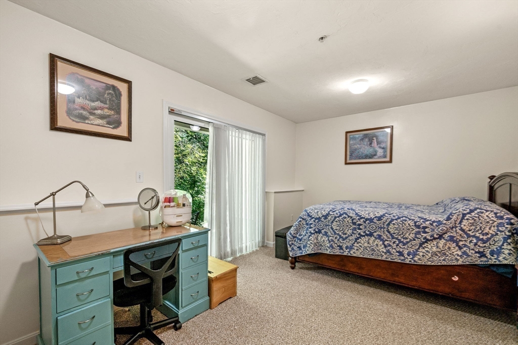35 Collins Street, Unit 73 Danvers, MA 01923 - Photo 25 of 30 a bedroom with a bed and a dresser